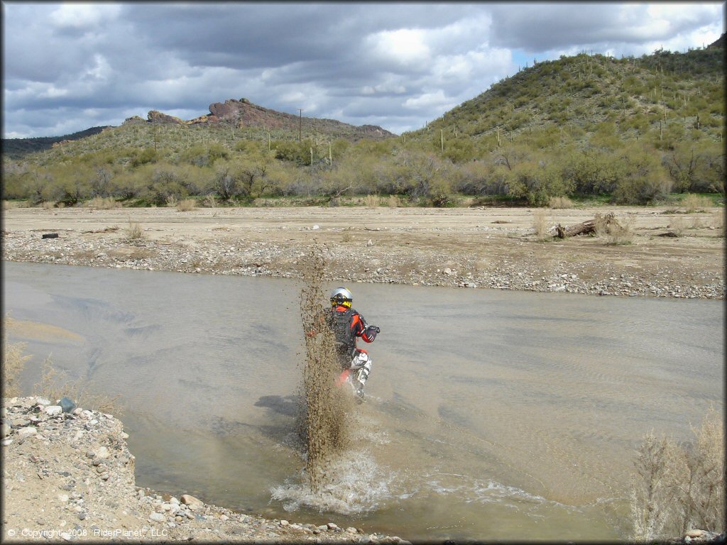Honda CRF Dirt Bike traversing the water at Black Hills Box Canyon Trail