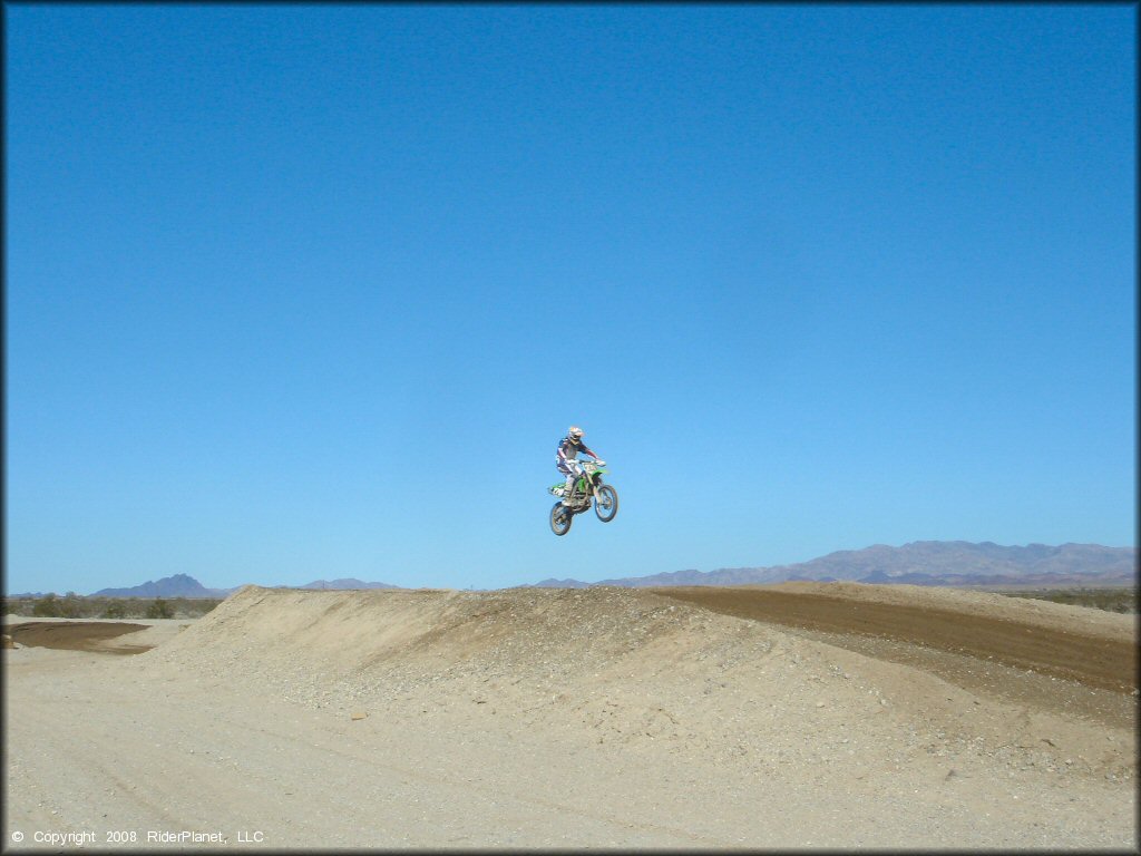Kawasaki KX Motorcycle getting air at River MX Track