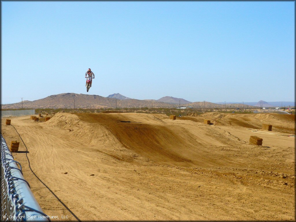 Honda CRF Motorcycle jumping at Cal City MX Park OHV Area