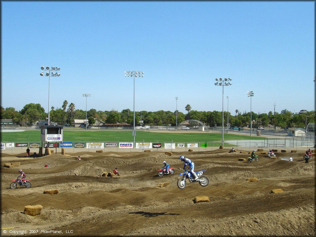 Yamaha YZ Dirt Bike getting air at Los Banos Fairgrounds County Park Track