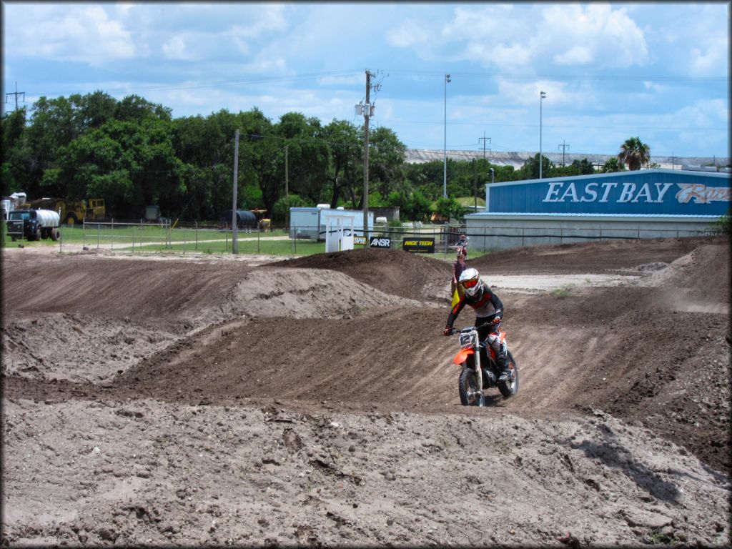 Young man on Honda dirt bike going through section of motocross track.