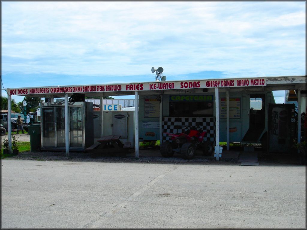 Red Honda ATV parked at concession stand.