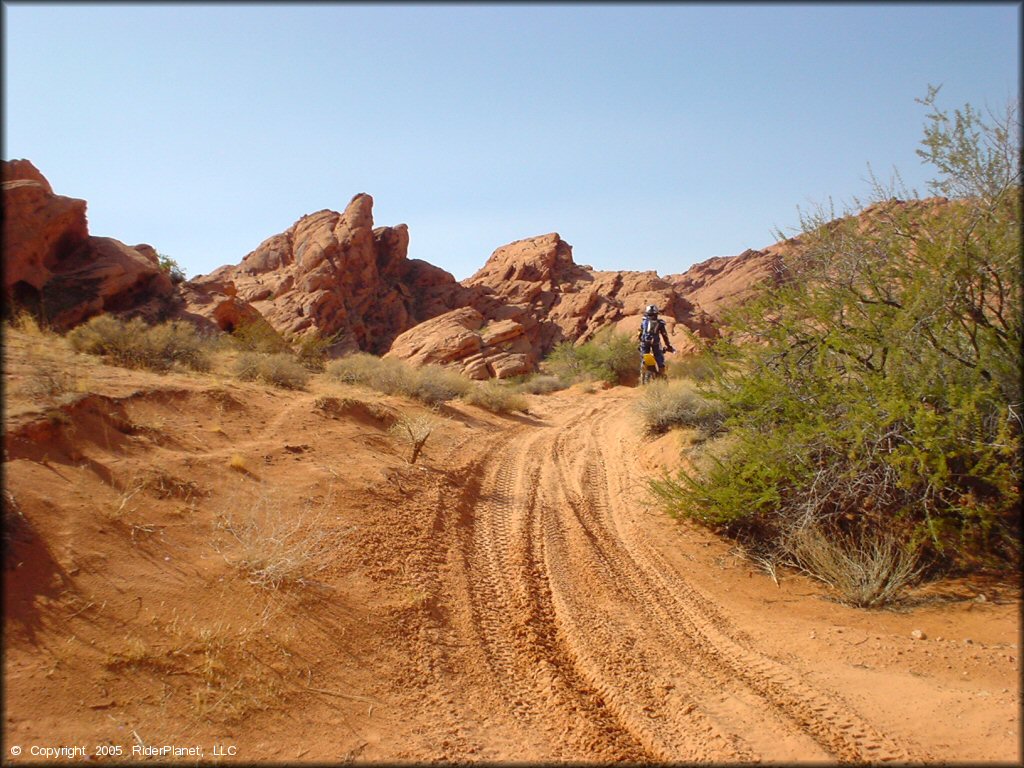 RM-100 going over sandy section of trail.