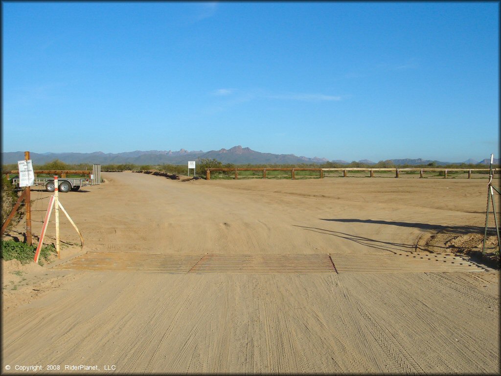 Flat parking area with cattle guard.