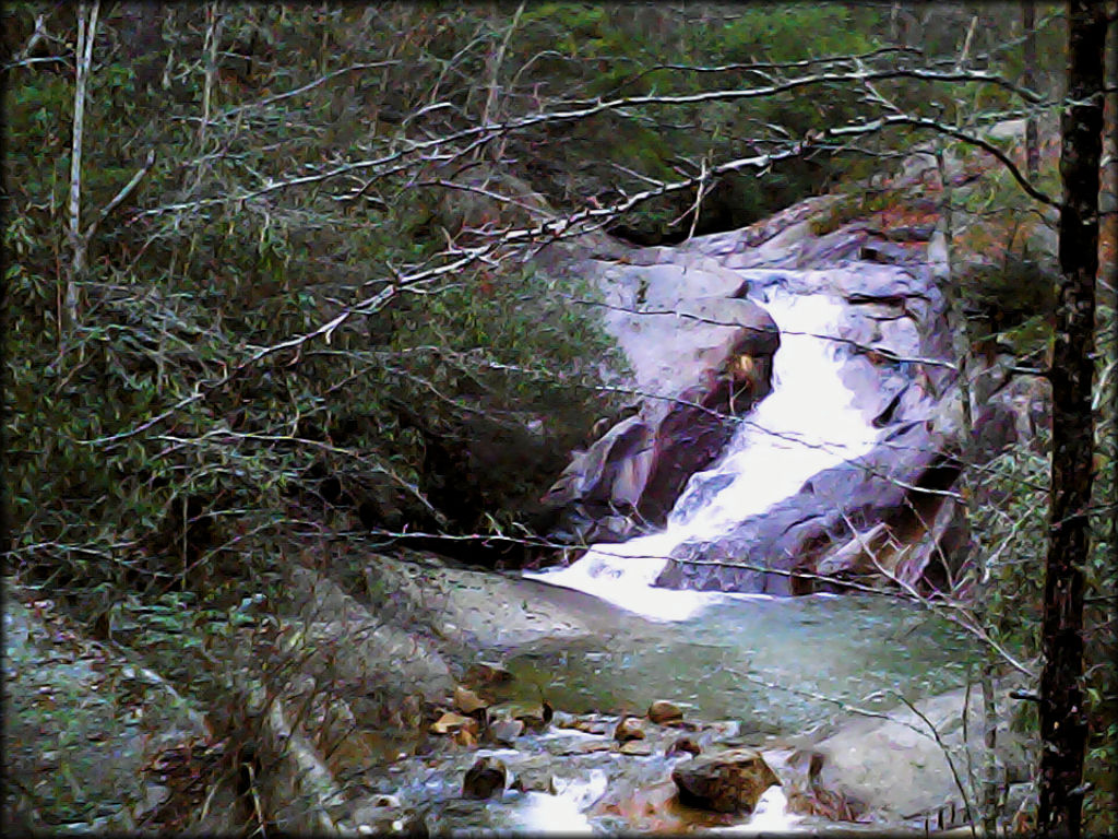 Swimming hole fed by shallow stream.