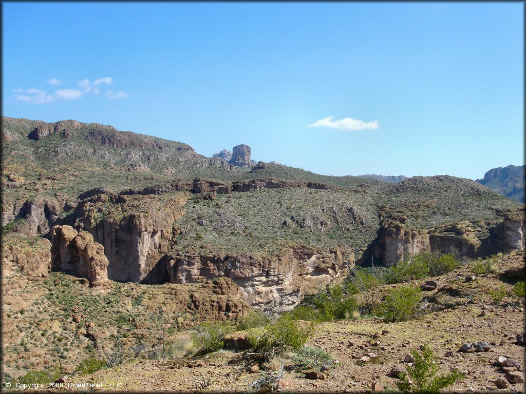 A scenic view of desert cliffs and canyons.