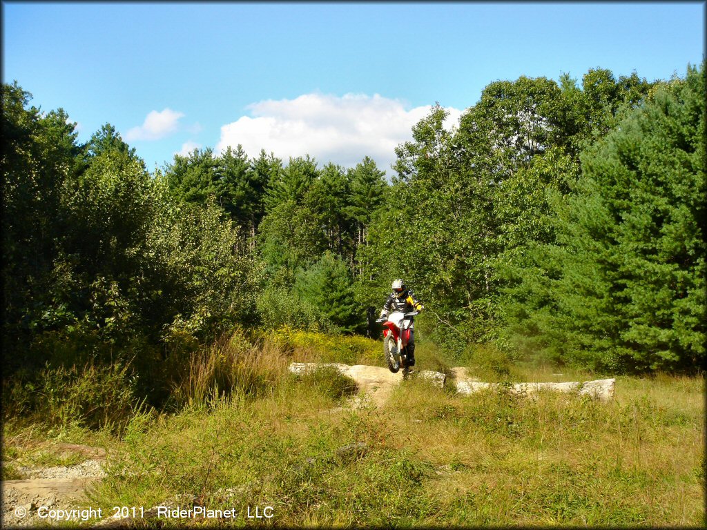 Honda CRF Motorcycle catching some air at Hodges Village Dam Trail