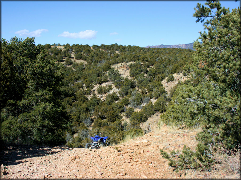 Scenic view of Yamaha Raptor parked on rocky hill.