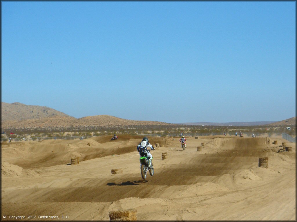 Kawasaki KX Motorbike getting air at Cal City MX Park OHV Area