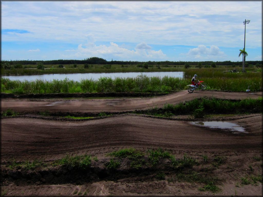 Man riding motocross bike on track.