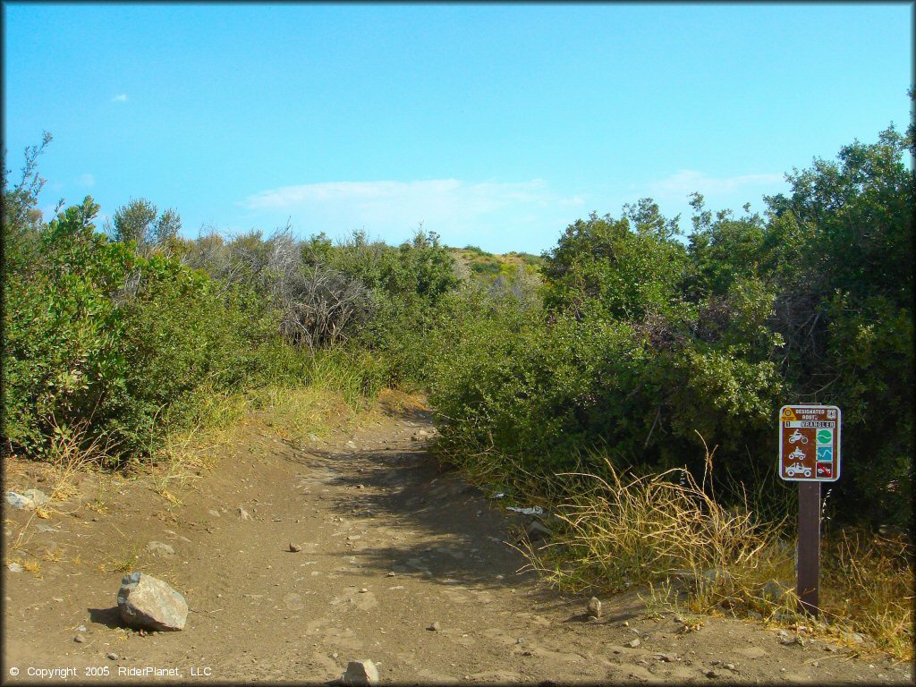 ATV trail with Forest Service signage.