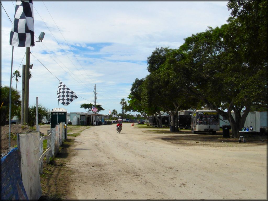 Rider exiting motocross track and heading toward concession stand.