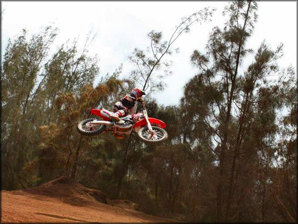 Honda CRF Dirtbike getting air at Kahuku Motocross Park OHV Area