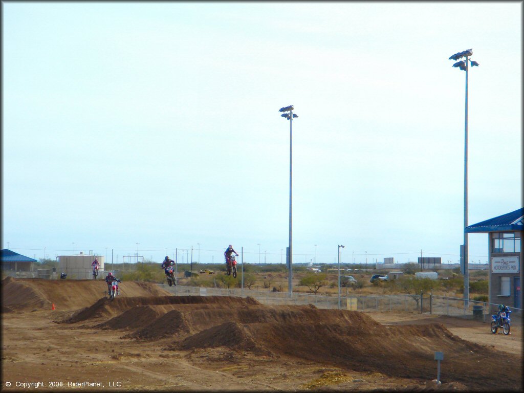 Honda CRF Motorcycle getting air at M.C. Motorsports Park Track