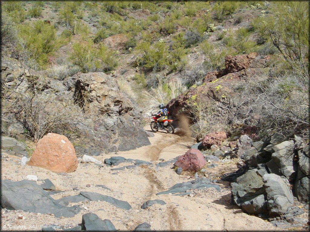 Honda CRF Motorcycle crossing some water at Black Hills Box Canyon Trail