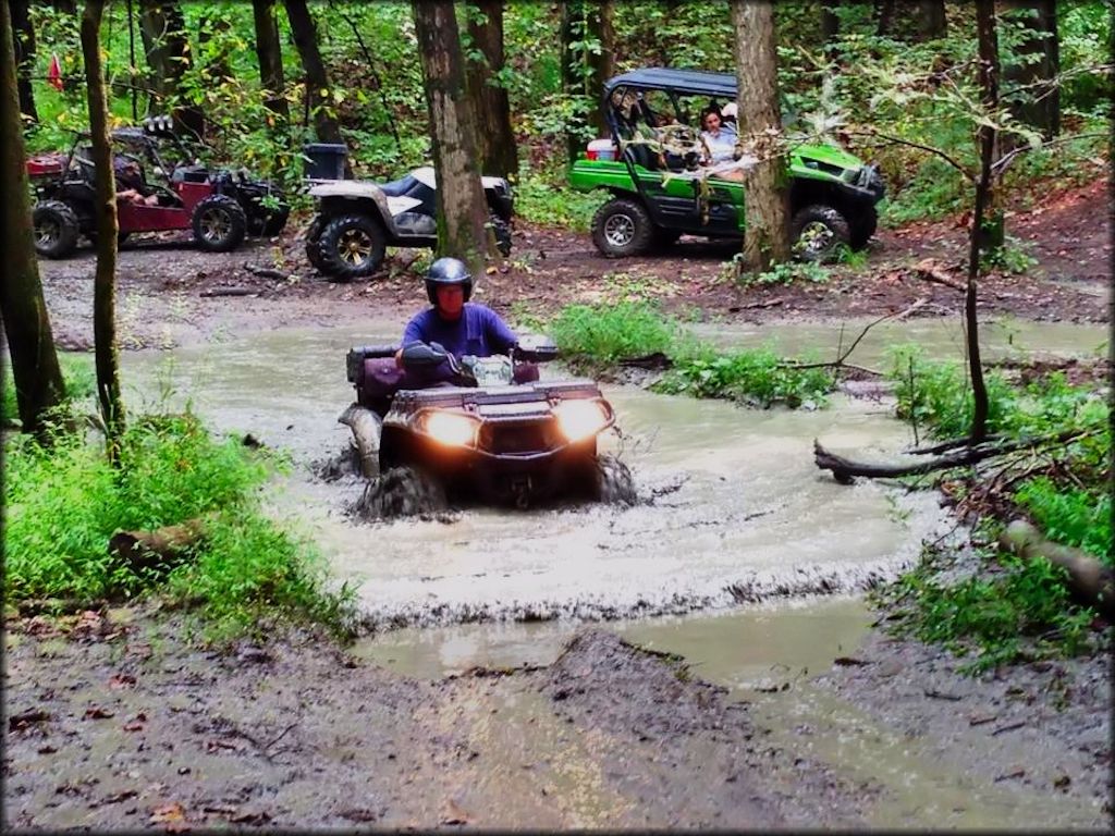 Rider and ATV going through a deep water crossing.