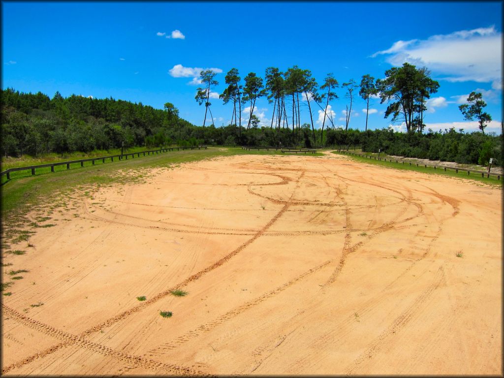 Flat but hard packed dirt parking area.