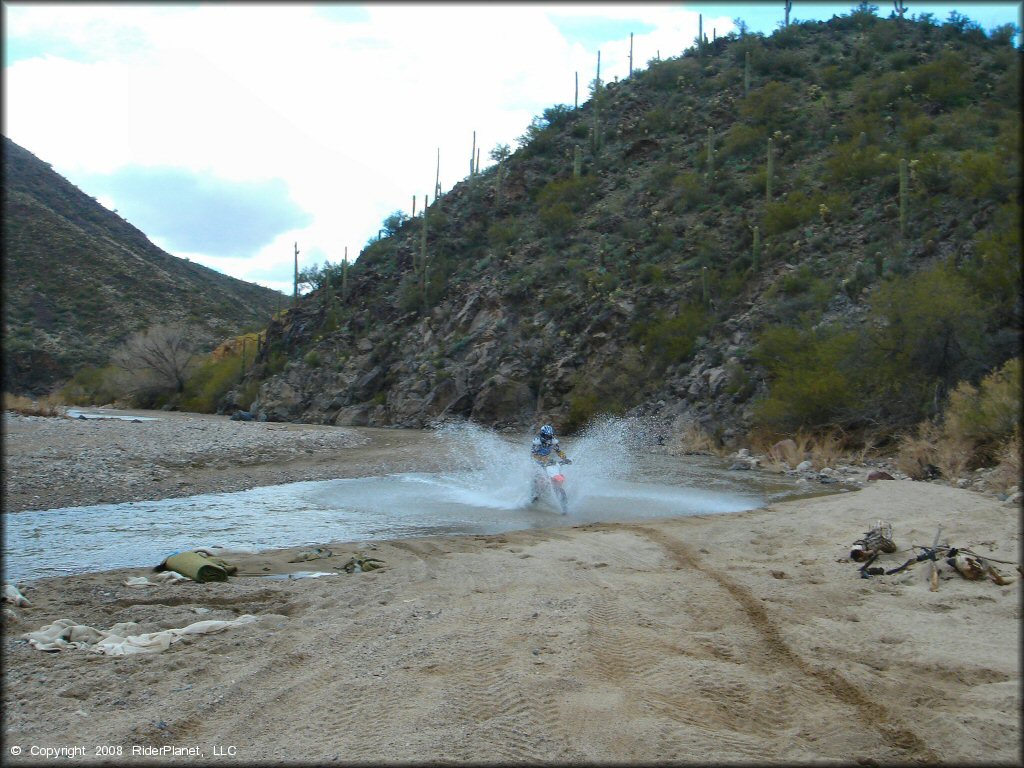 Honda CRF Motorcycle crossing some water at Black Hills Box Canyon Trail