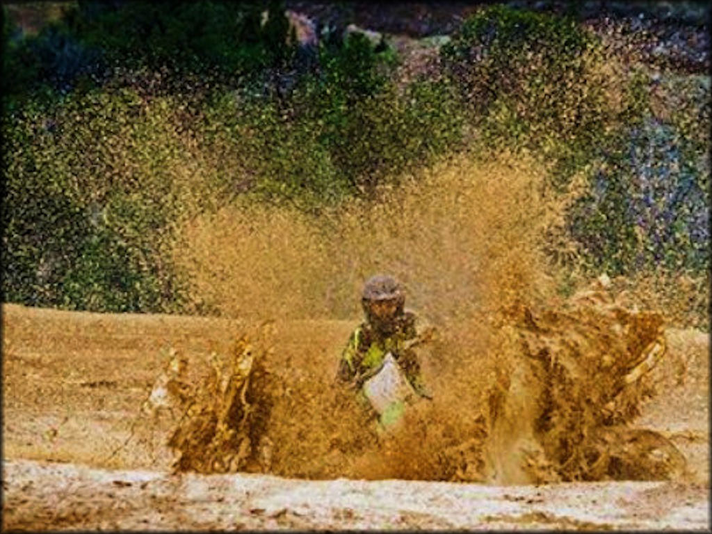 A Kawaski Motorcycle Traversing a Large Mud Puddle