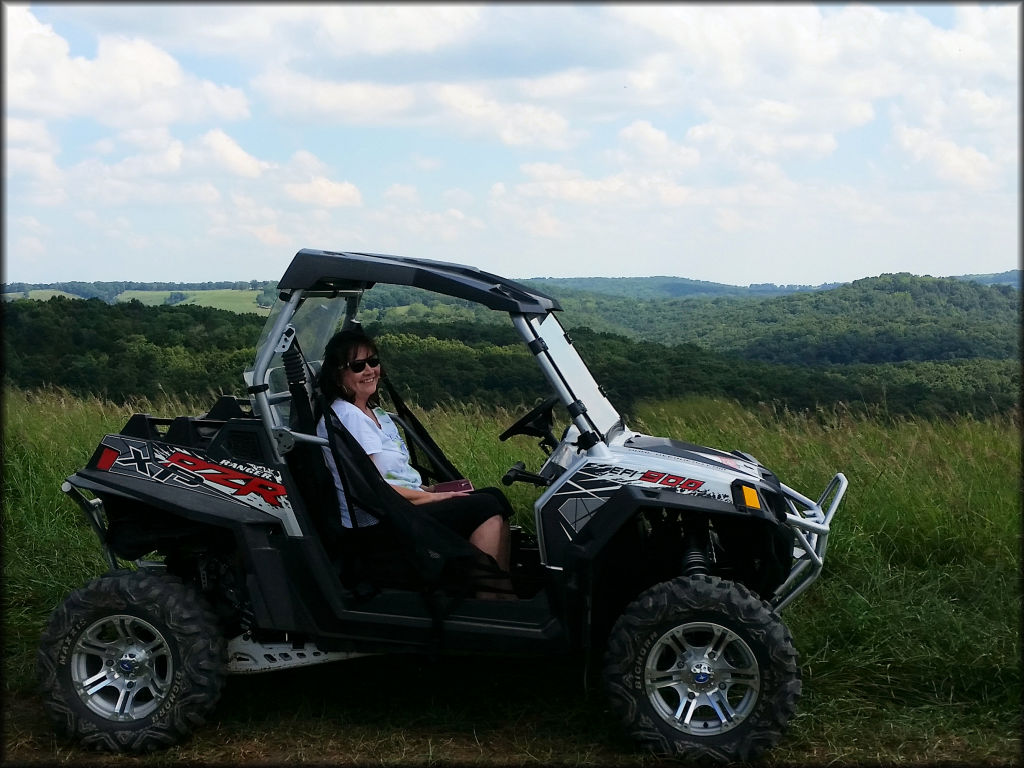Polaris RZR XP Ranger 900 parked in front of a scenic backdrop.