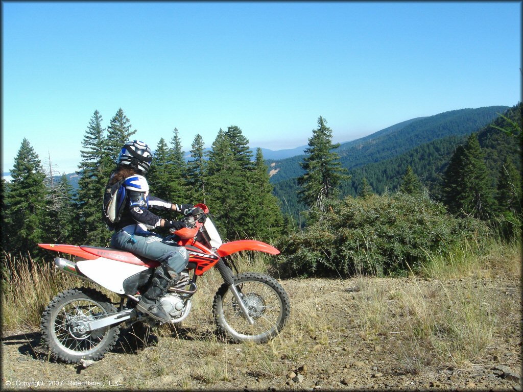 Woman riding a Honda CRF Dirt Bike at Pilot Creek OHV Trails