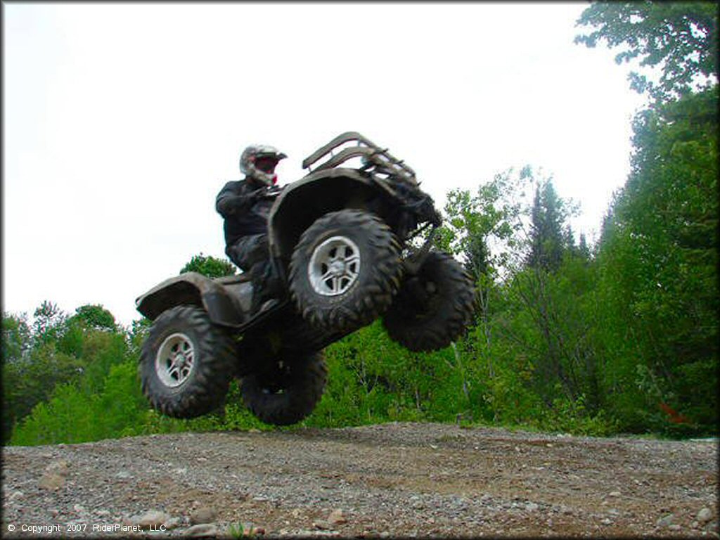 All Terrain Vehicle catching some air at Katahdin Lodge Trail