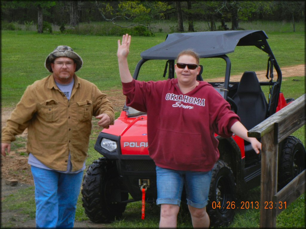 Red Polaris UTV with black aftermarket hard roof.