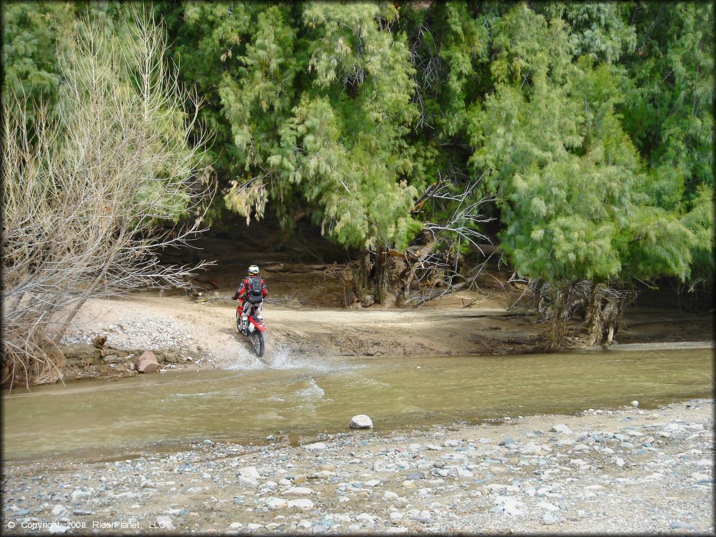 Honda CRF Motorcycle crossing the water at Black Hills Box Canyon Trail